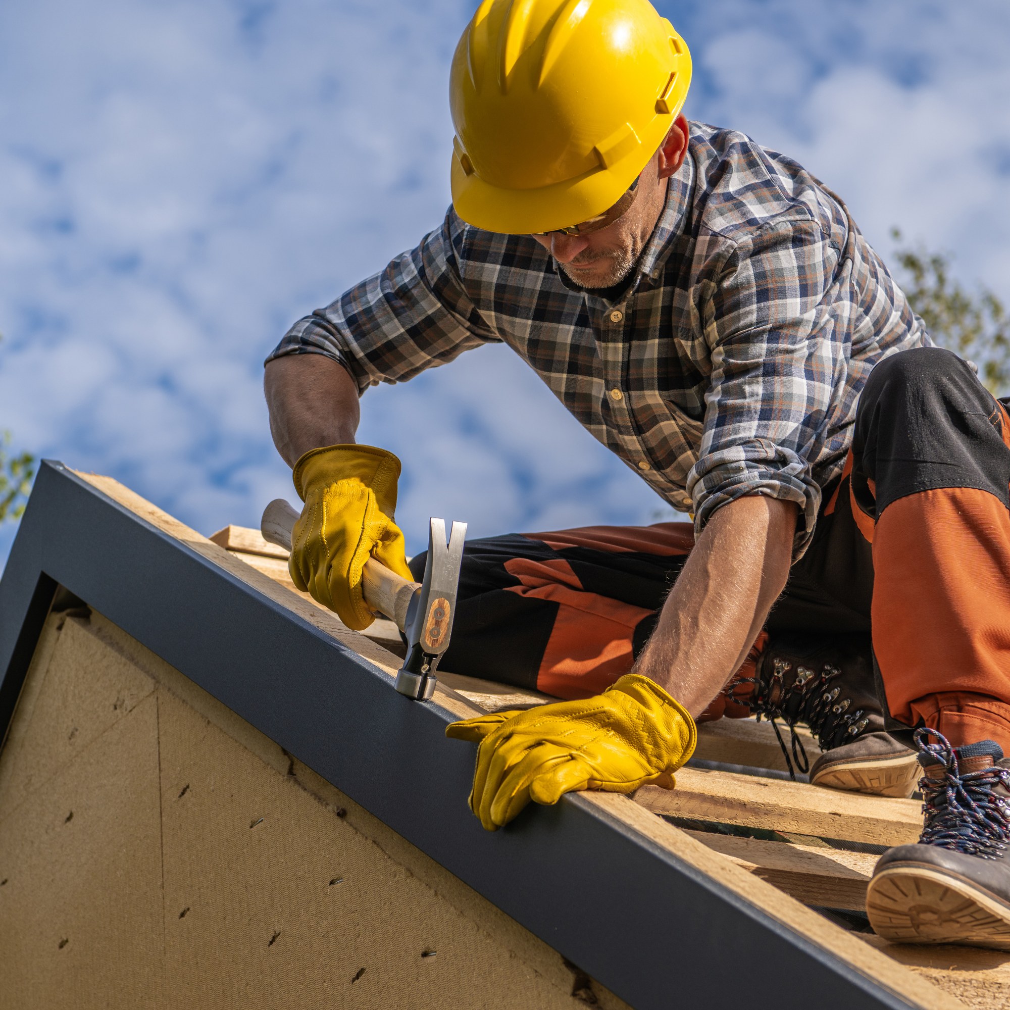 Commercial roof repairs and replacement Adelaide — roofing contractor inspecting a commercial metal deck roof